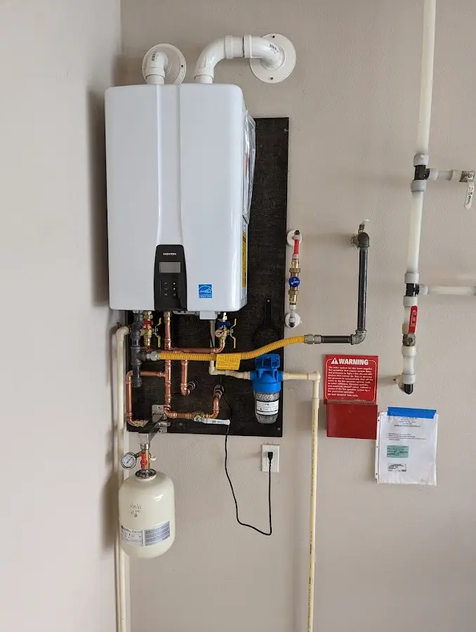 Professional plumber installing copper piping in a Burgaw home